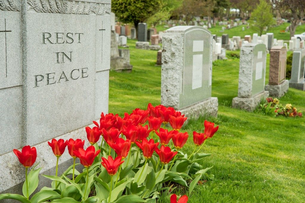 a tombstone with tulips