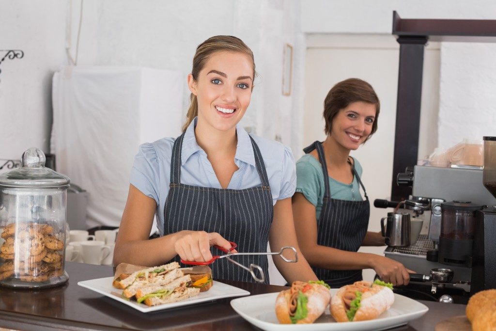 Women serving sandwiches