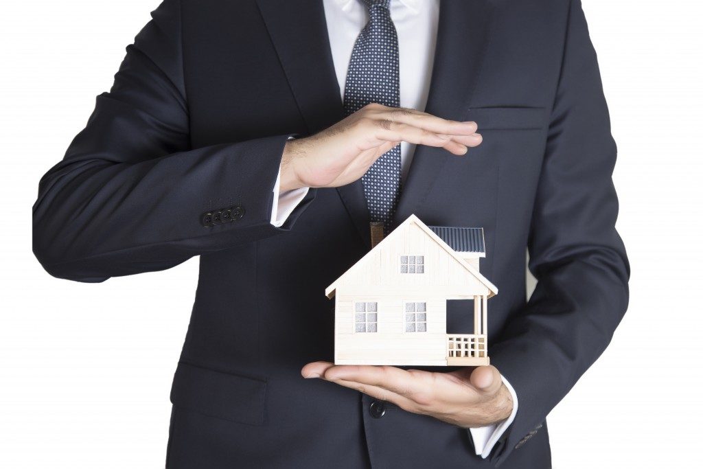 realtor holding a model house