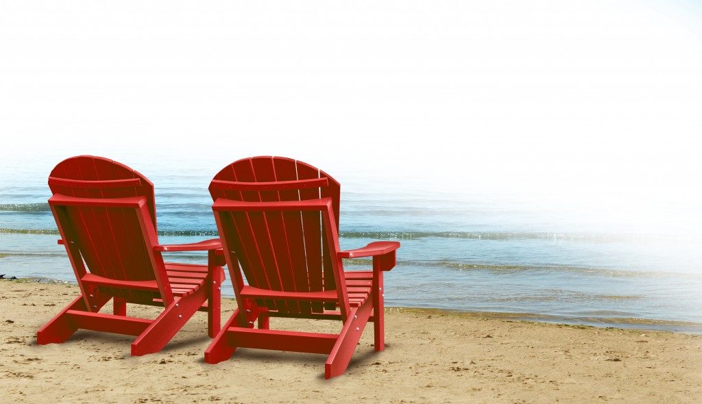 red wooden chairs by the beach