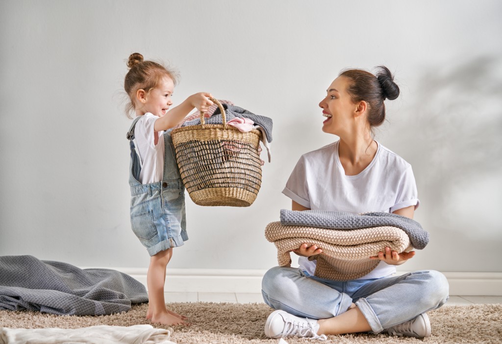 mother and daughter doing laundry